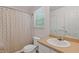 Clean bathroom featuring a vanity, sink, mirror, toilet, and a shower with a neutral patterned curtain at 1450 Steam Engine Way, Conyers, GA 30013