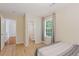 Bedroom showcasing light wood floors, window and doorway view to an en-suite bathroom at 1450 Steam Engine Way, Conyers, GA 30013