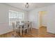 Dining room showcasing hardwood floors, a window, white walls, and a gray table at 1450 Steam Engine Way, Conyers, GA 30013
