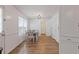 Bright dining room with hardwood floors, white walls, and a modern chandelier above the table at 1450 Steam Engine Way, Conyers, GA 30013