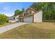 Two-story home with stone and siding exterior, garage, and large driveway at 1450 Steam Engine Way, Conyers, GA 30013