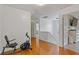 Hallway leading to bedroom with exercise bike to the left and tv to the right at 1450 Steam Engine Way, Conyers, GA 30013