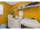 Functional laundry room with modern washer and dryer, complemented by convenient shelving for storage at 1450 Steam Engine Way, Conyers, GA 30013