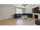 Living room showcasing hardwood floors, fireplace and a plush dark grey sectional sofa at 1450 Steam Engine Way, Conyers, GA 30013