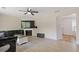 Bright living room with hardwood floors, a fireplace, and a dark grey sofa at 1450 Steam Engine Way, Conyers, GA 30013