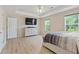 Large main bedroom featuring wood floors, a tray ceiling, and windows with tree views at 1450 Steam Engine Way, Conyers, GA 30013
