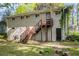 View of the home's back exterior with a second-story deck and stairs to the yard at 3693 Larkspur Ter, Decatur, GA 30032