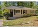 Charming one-story home with black shutters and door and a stone walkway at 3693 Larkspur Ter, Decatur, GA 30032