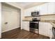 Updated kitchen features stainless steel appliances, granite countertops, and custom cabinetry at 3693 Larkspur Ter, Decatur, GA 30032