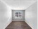 Bright bedroom with dark flooring, a neutral gray walls, and a window with natural light at 5854 Cobalt Dr, Powder Springs, GA 30127