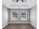 Bright bedroom with wood-look floors, neutral walls, and two windows at 5854 Cobalt Dr, Powder Springs, GA 30127