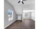 Bright bedroom with vaulted ceiling, dark flooring, and abundant natural light from two windows at 5854 Cobalt Dr, Powder Springs, GA 30127