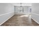 Spacious dining room featuring modern lighting and wood floors. Ready for hosting! at 5854 Cobalt Dr, Powder Springs, GA 30127