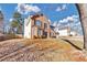 Picturesque brick home with a two-car garage, framed by a mature tree and lush landscape at 5854 Cobalt Dr, Powder Springs, GA 30127