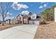 Inviting two-story home with a spacious driveway and attached two-car garage in a residential neighborhood at 5854 Cobalt Dr, Powder Springs, GA 30127