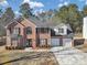 Charming two-story brick home features a two-car garage, manicured lawn, and classic curb appeal at 5854 Cobalt Dr, Powder Springs, GA 30127