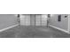 Spacious two-car garage with white doors, clean concrete floors and good lighting at 5854 Cobalt Dr, Powder Springs, GA 30127