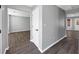 Hallway with wood flooring and access to multiple rooms, showcasing the home's layout at 5854 Cobalt Dr, Powder Springs, GA 30127