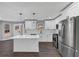 Eat-in kitchen with stainless steel appliances, island, tile backsplash, and bright white cabinets at 5854 Cobalt Dr, Powder Springs, GA 30127