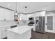 Modern kitchen with white cabinets, tile backsplash, stainless appliances, and a center island at 5854 Cobalt Dr, Powder Springs, GA 30127