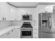 Updated kitchen featuring stainless steel appliances, gas range, and white cabinets at 5854 Cobalt Dr, Powder Springs, GA 30127
