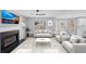 Bright living room with fireplace, ceiling fan, neutral colors, and large window views at 5854 Cobalt Dr, Powder Springs, GA 30127