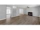 Open-concept living room with hardwood floors, fireplace, and staircase at 5854 Cobalt Dr, Powder Springs, GA 30127