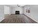 Inviting living room featuring hardwood floors, a fireplace, and plenty of natural light at 5854 Cobalt Dr, Powder Springs, GA 30127