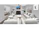 Bright living room featuring neutral-toned furniture, a fireplace, and plenty of natural light from a large window at 5854 Cobalt Dr, Powder Springs, GA 30127