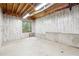 Unfinished basement featuring concrete floor, painted walls, and natural light from a window at 936 Bramble Oak Ct, Powder Springs, GA 30127