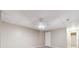 Spacious basement featuring carpet floors, tile ceiling, and a white door for entry at 936 Bramble Oak Ct, Powder Springs, GA 30127