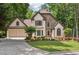 Charming home with stone accents, manicured lawn, lush landscaping, and a two-car garage at 936 Bramble Oak Ct, Powder Springs, GA 30127