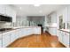 Spacious kitchen features white cabinets, stainless steel appliances, and open layout at 936 Bramble Oak Ct, Powder Springs, GA 30127