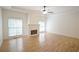 Bright living room boasts a ceiling fan, fireplace, hardwood floors, and abundant natural light at 936 Bramble Oak Ct, Powder Springs, GA 30127