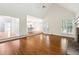 Open floorplan hardwood living room with stone fireplace and view to kitchen at 936 Bramble Oak Ct, Powder Springs, GA 30127