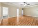 Spacious main bedroom with hardwood floors, tray ceiling with fan, and doorways leading to other rooms at 936 Bramble Oak Ct, Powder Springs, GA 30127