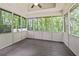 Screened in back porch featuring wooden floors and beautiful view at 936 Bramble Oak Ct, Powder Springs, GA 30127