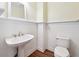 Traditional powder room featuring white beadboard and pedestal sink at 936 Bramble Oak Ct, Powder Springs, GA 30127