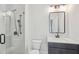 Modern bathroom featuring a glass-enclosed shower with matte black fixtures and a sleek vanity with elegant mirror at 123 Cricket Ln, Alpharetta, GA 30009