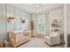 Charming Bedroom with crib, rocker, and playful decor at 123 Cricket Ln, Alpharetta, GA 30009