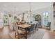 Dining room flows into the modern kitchen, featuring a large window and an elegant chandelier at 123 Cricket Ln, Alpharetta, GA 30009