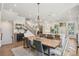 Open-concept dining area with staircase, view of the modern kitchen, and stylish chandelier at 123 Cricket Ln, Alpharetta, GA 30009