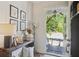 Tastefully decorated entryway with a wooden console table and artwork, leading to a covered front porch at 123 Cricket Ln, Alpharetta, GA 30009