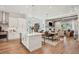Open-concept kitchen featuring a center island, stainless steel appliances, and seamless flow to the dining and living areas at 123 Cricket Ln, Alpharetta, GA 30009