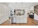 Bright open-concept kitchen with island, seamlessly blending into living and dining spaces with modern décor at 123 Cricket Ln, Alpharetta, GA 30009