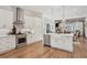 Spacious kitchen with stainless steel appliances, white cabinetry, a center island and open layout to the dining room at 123 Cricket Ln, Alpharetta, GA 30009