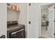 Laundry area with modern washer/dryer and storage shelf at 123 Cricket Ln, Alpharetta, GA 30009
