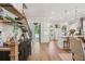 Bright and inviting living area featuring wood floors, open shelves, and a view into the modern kitchen at 123 Cricket Ln, Alpharetta, GA 30009