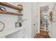Cozy home office with wood shelving, white cabinets, and natural light at 123 Cricket Ln, Alpharetta, GA 30009