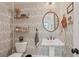 Chic powder room with patterned wallpaper, a pedestal sink, and modern accents at 123 Cricket Ln, Alpharetta, GA 30009